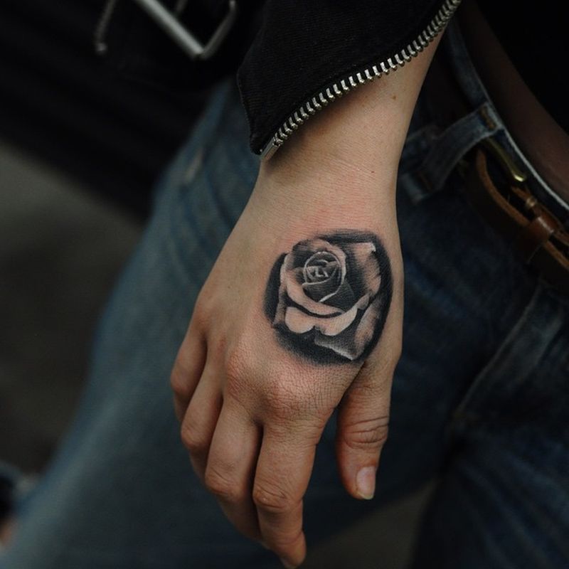 Dark Grey Turbo And Rose Flower Tattoo On Forearm