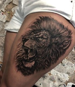black and gray realistic lion tattoo