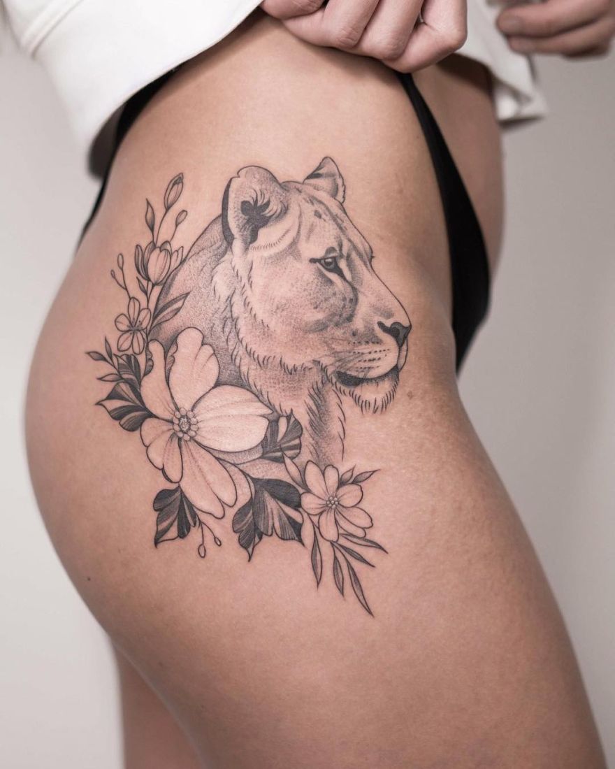 lioness tattoo with flowers